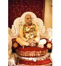 Srila Prabhupada on Cream Colored Vyasanasna with Many Flower Garlands