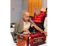 Srila Prabhupada Playing Harmonium