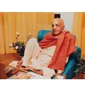 Srila Prabhupada Sitting Relaxed on Blue Seat